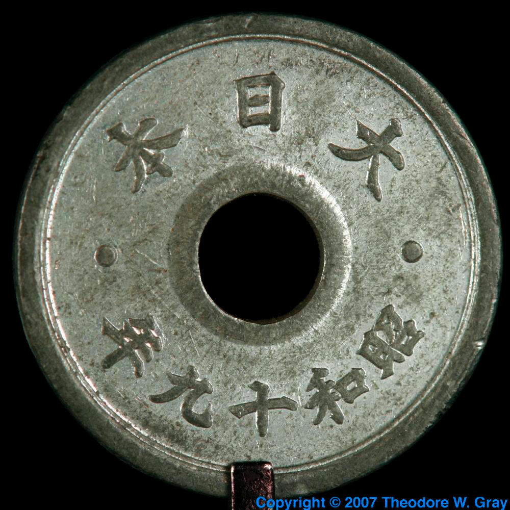 Old tin coin, a sample of the element Tin in the Periodic Table